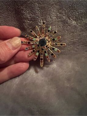 Vintage gold tone brooch with colorful rhinestones, center blue stone, excellent